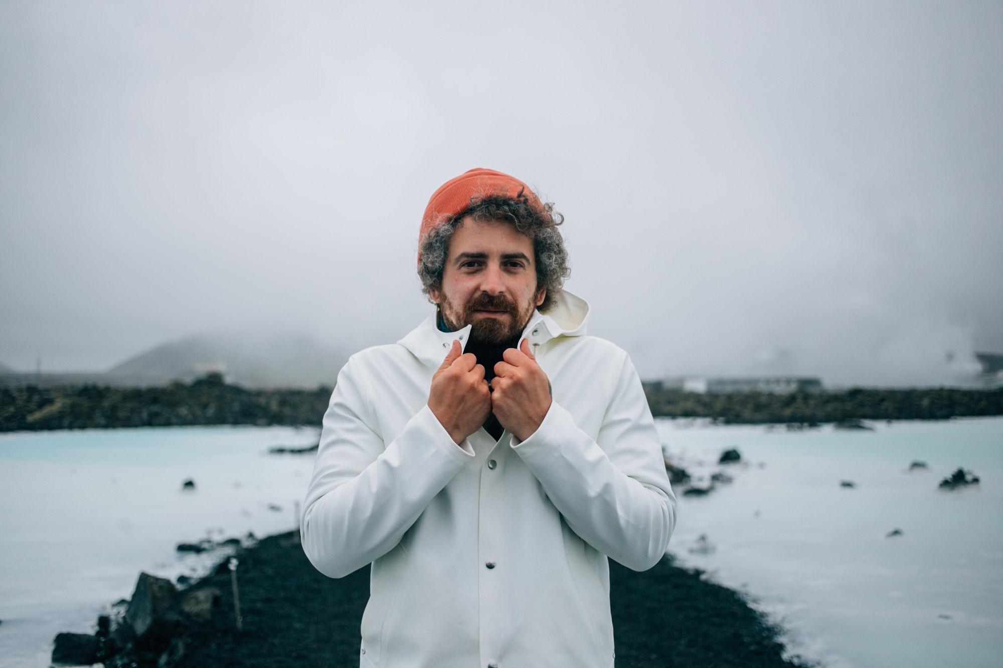Cold man in white raincoat in iceland